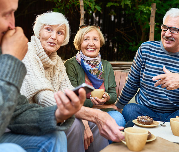 group of seniors chatting over coffee